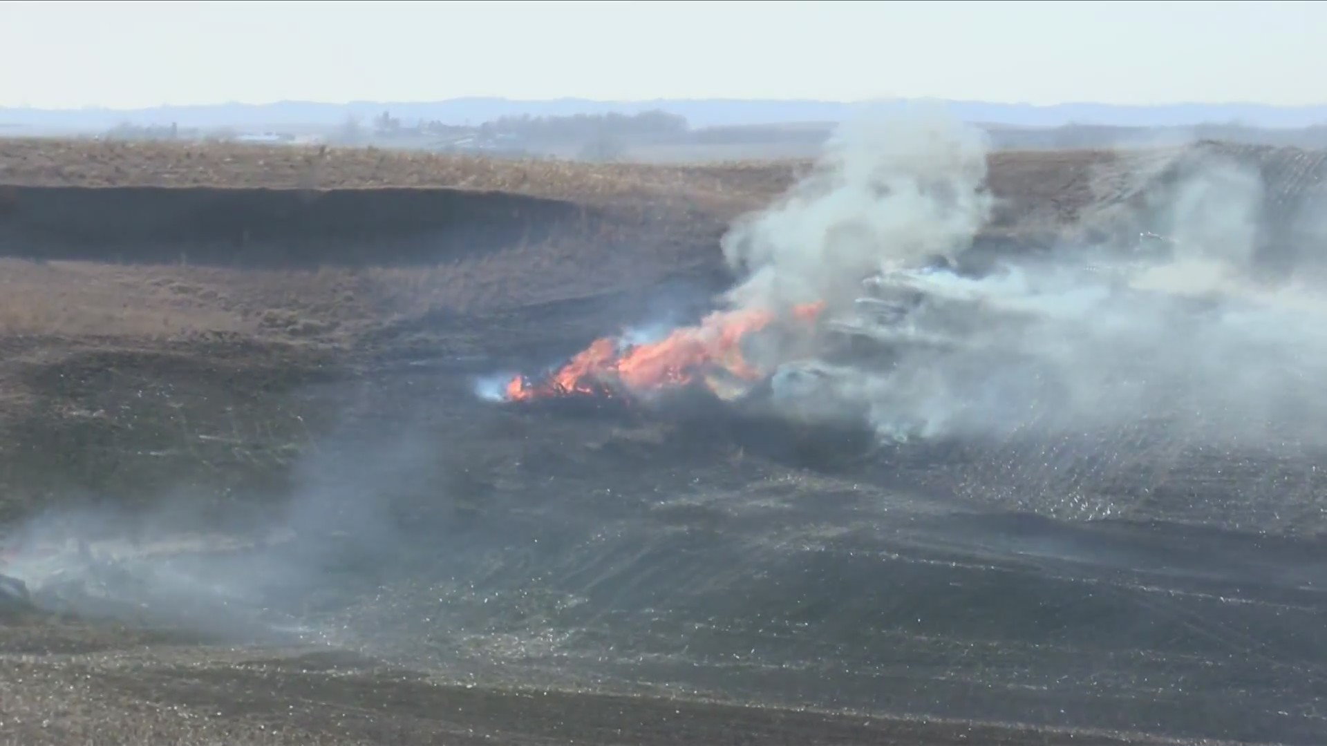 Fire Departments and Farmers Battle Field Fire Near Anthon, Iowa