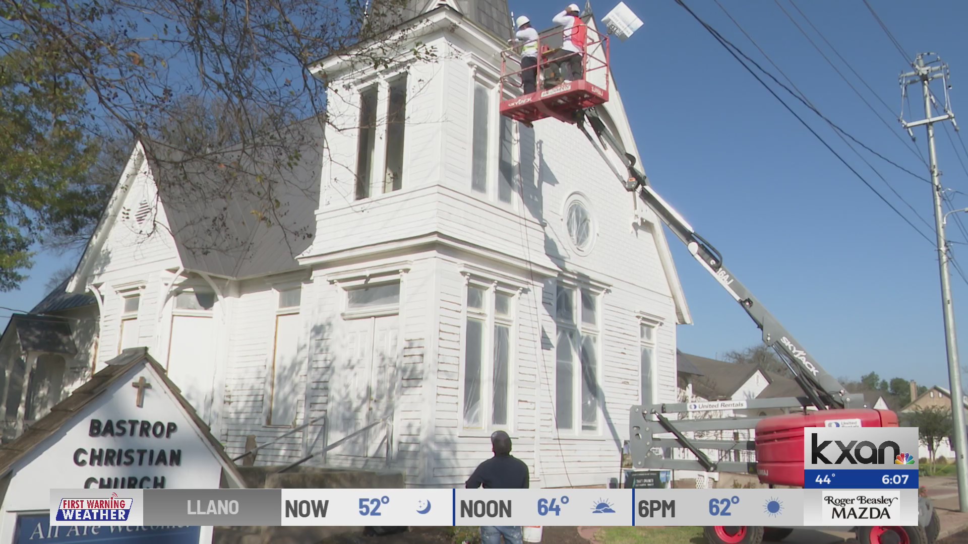 Bastrop business painting historic church to help with massive