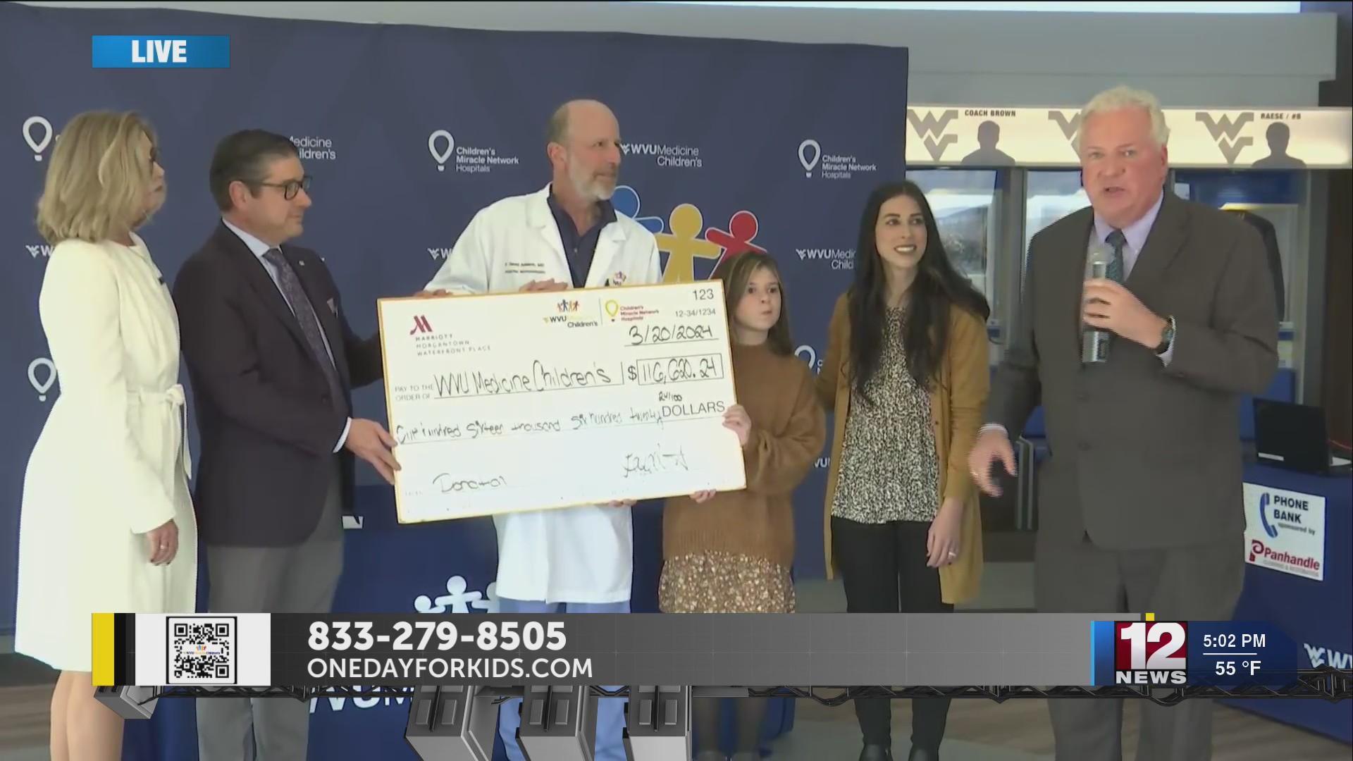 Marriott Waterfront Place presents check at WVU Medicine